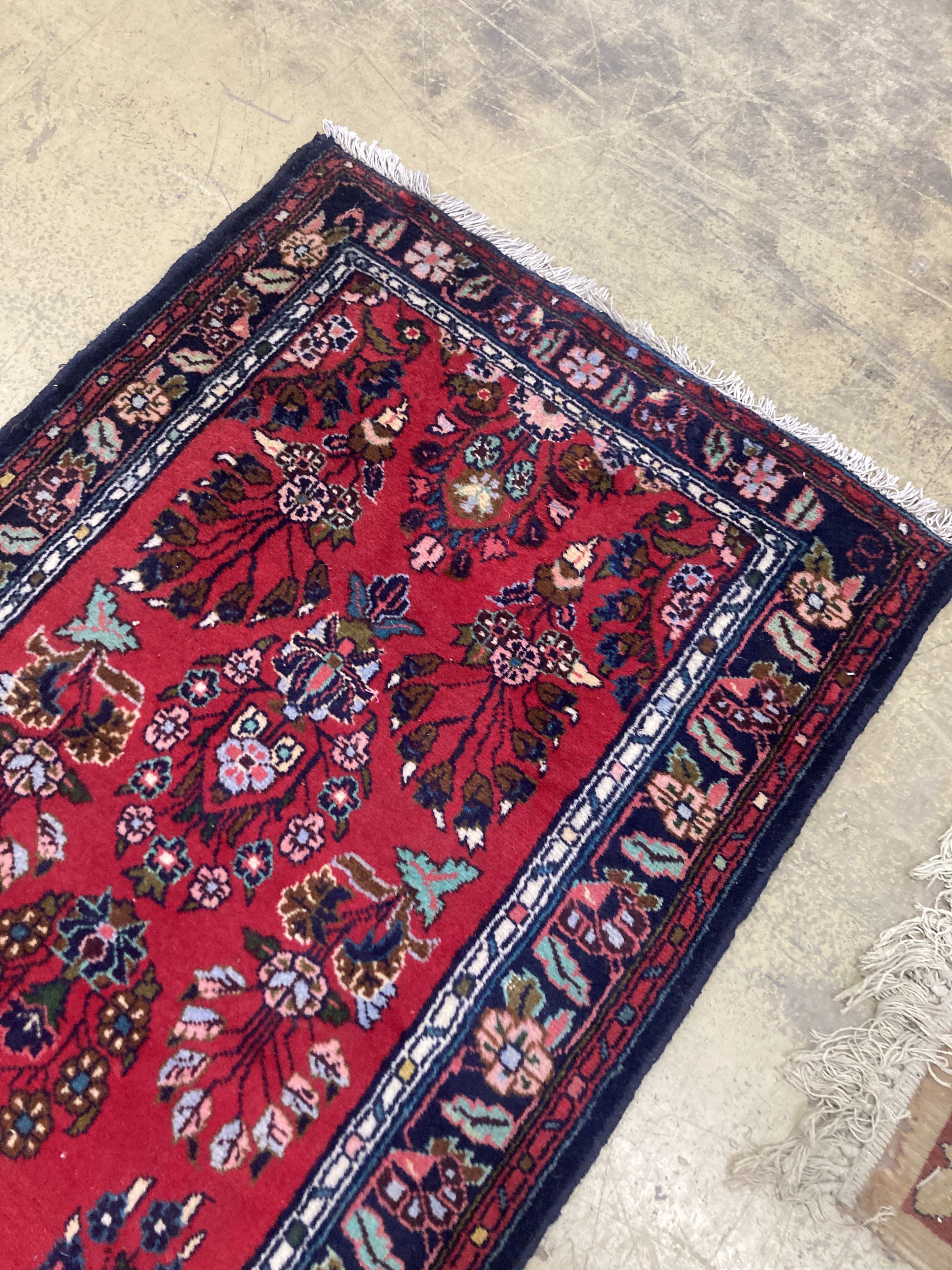 A Hamadan red ground runner with floral design, 280 x 84cm